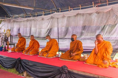 Food offering or food donation to Thai monks as part of a religious and Buddhist ritual in Thailand Southeast Asia