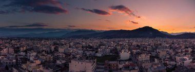 A panoramic shot of a sunset sky over the city Argos, Argolis, Greece clipart