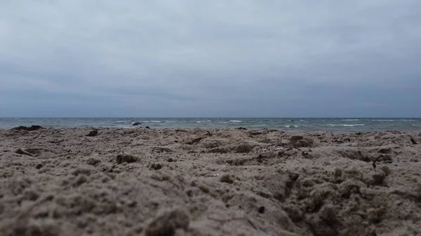Ένα Κοντινό Πλάνο Της Παραλίας Βραχώδη Άμμο Θάλασσα Στο Παρασκήνιο — Φωτογραφία Αρχείου