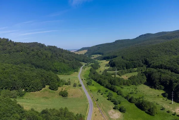 landscape of a road among hills and forests seen from above, rural, green