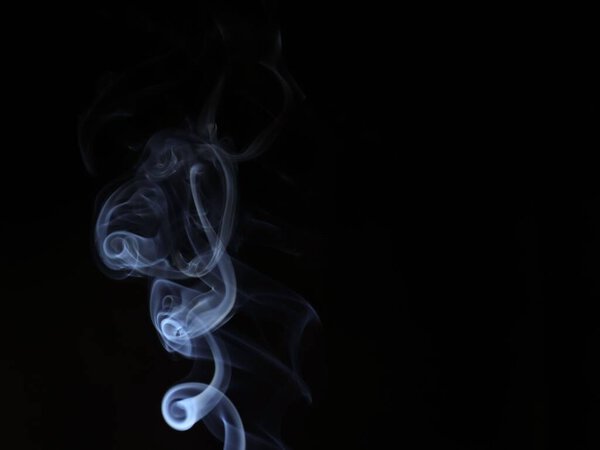 A closeup of an abstract white smoke on a black background