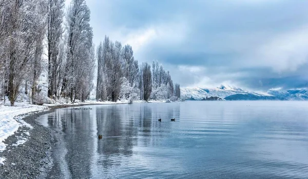 A scenic view of the crystal waters of Lake Wanaka in winter, South Island, New Zealand
