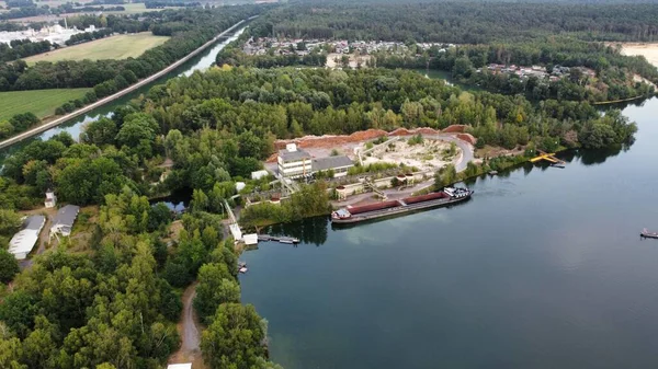 A bird\'s eye view of a loaded ship in a lake near a building at Haltern, Germany