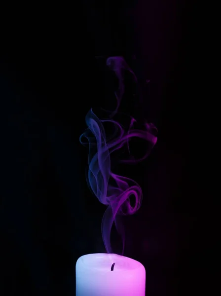 A candle with smoke and neon lights