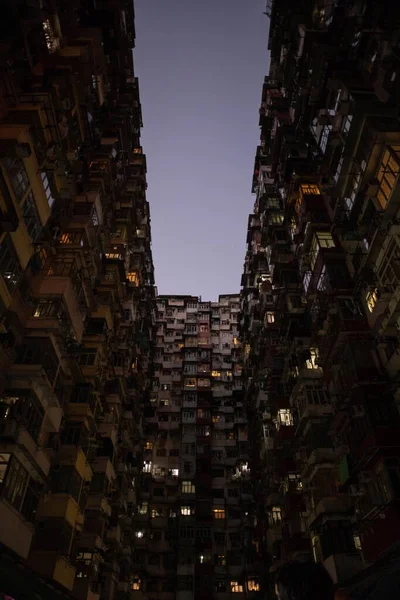 夜の間に狭いアパートの建物の垂直ショット — ストック写真