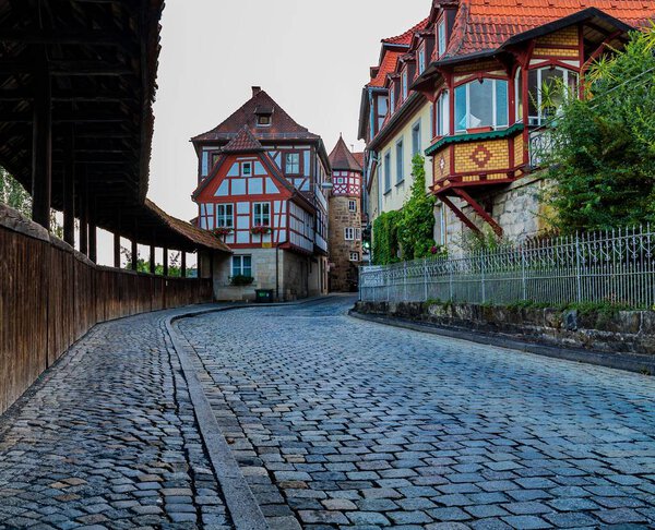 A cobblestone street and houses in a town in Germany