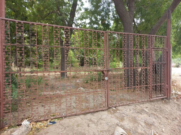 A red steel gate on the house