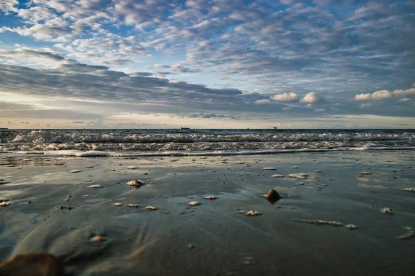 青い空の下で泡立つ波が美しい海の景色 — ストック写真