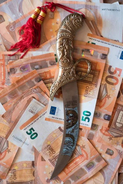 Arabic gold knife on many banknotes