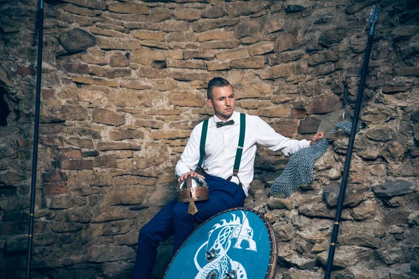 古代の城にポーズをとる盾と槍を持ったスーツの男 — ストック写真