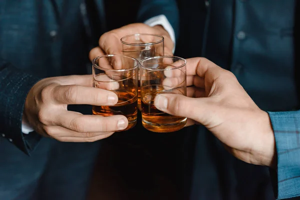 Men drink whiskey.Person holding a glass