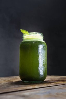 Gri arka planı olan ahşap bir masada soğuk naneli limonata.