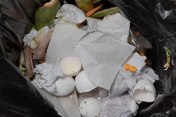 Close up of a garbage can with rubbish inside