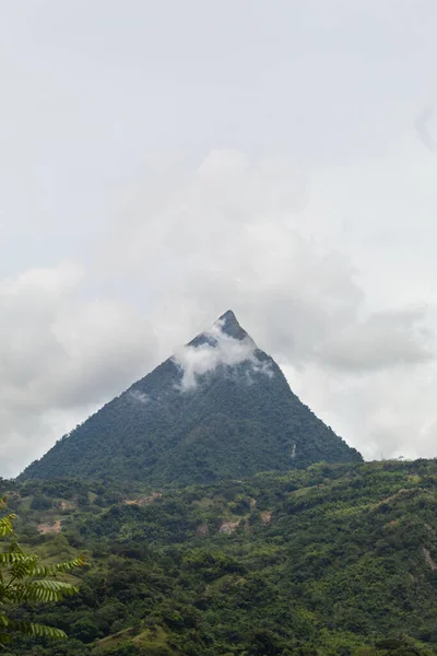 Vertical Shot Pyramid Shaped Mountain Clouds Front Lots Vegetation Foreground — 스톡 사진