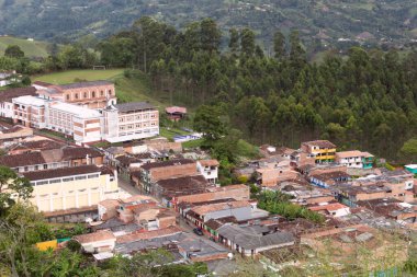 Brick houses on a mountain with trees around