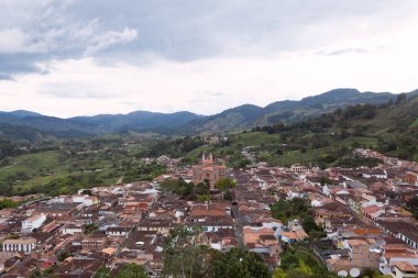 Panoramic image of a Colombian town with brick houses surrounded by many mountains. Jerico, Colombia.