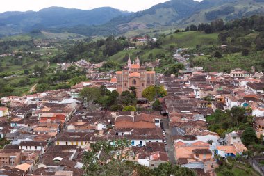 Brick houses and a church located on the side of a mountain. Jerico, Colombia.