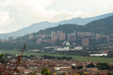 A city seen from a viewpoint with mountains in the background