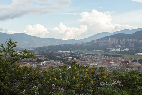 A city surrounded by mountains seen from a lookout point