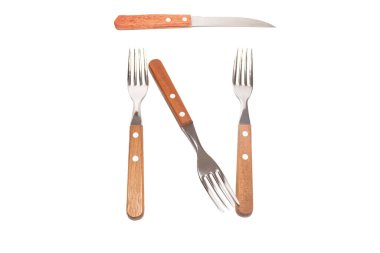 3 forks and 1 knife with a wooden handle making the letter spanish N on a white background