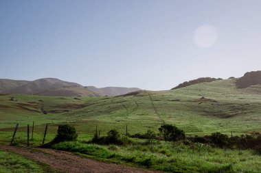 Rolling green hills countryside fence