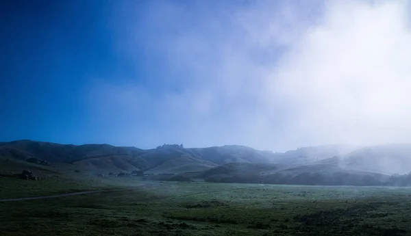 Blue sky rolling hills California early morning fog