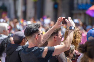 June 26, 2022, San Francisco California, Pride Parade, two parade bystanders viewing the parade. 