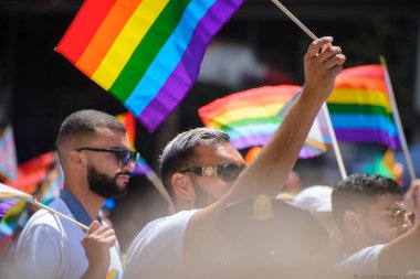 June 26, 2022, San Francisco California, USA, Bystanders Carrying Pride Flag and a Pride Flag with the Ukrainian Colors 