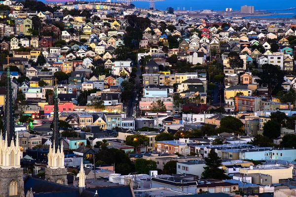 Rolling San Francisco hills with peaked roof homes and streets at golden hour