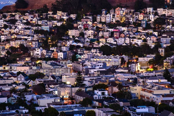 Rolling San Francisco hills with peaked roof homes and streets at golden hour