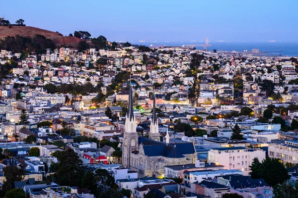 Rolling San Francisco hills with peaked roof homes and streets at golden hour