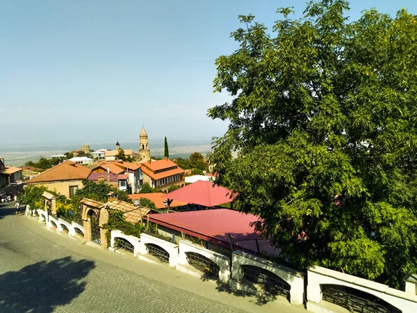 A panoramic view of Sighnaghi and a street where many loving couples are walking