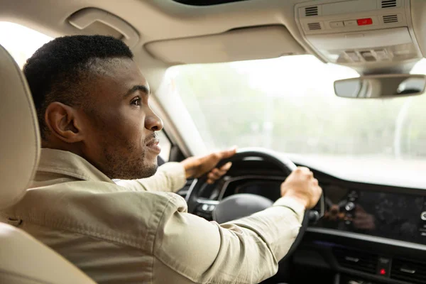 African american man driving a modern car. High quality photo