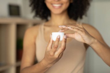 Tanınmayan çıplak bir Afrikalı kadının elinde bir kavanoz vücut kremi. Yüksek kalite fotoğraf