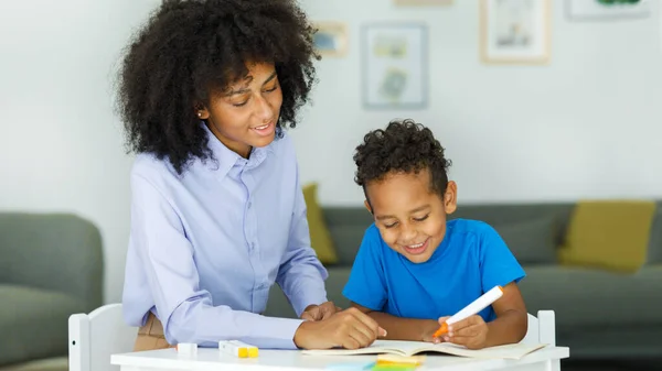 Female Infant School Teacher Working One One Young Schoolboy Sitting — Stock Photo, Image