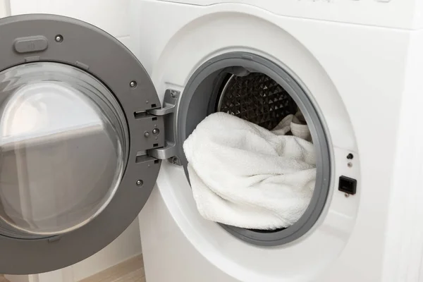Modern washing machine with clean or dirty clothes in the middle. High quality photo