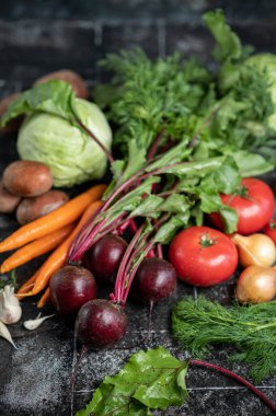 Set of vegetables on the table. View from above. Cabbage, potatoes, carrots, onions, tomatoes, garlic, dill. Vegetables for cooking Ukrainian borscht.