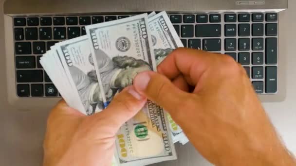 Man Counting 100 Dollar Bills His Laptop Slow Motion — Stockvideo