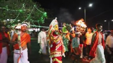 Udupi, India - Mar 7, 2020: An ancient ritual of worshiping spirit god with unique dance style. The devotees are following the performer entering the temple at Udupi, India
