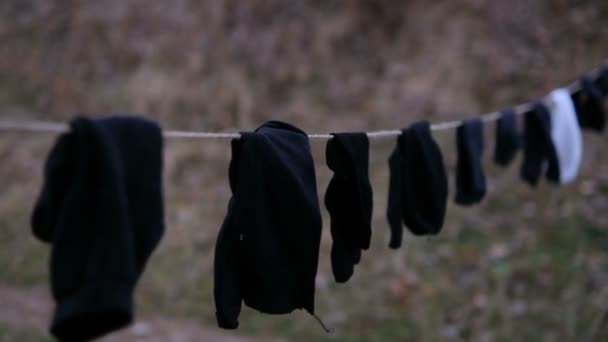 Socks in the wind hanging on rope to dry — 图库视频影像
