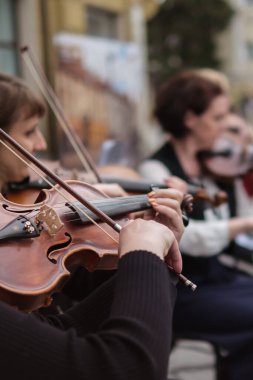Zhytomyr, Ukraine - May 15, 2021: woman street musician playing violin classical music.