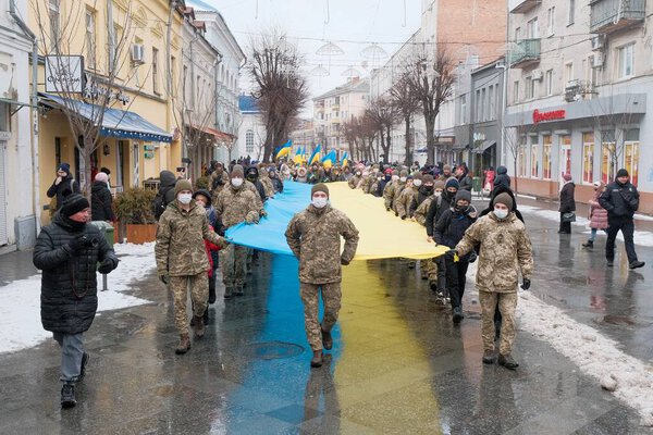 Zhytomyr, Ukraine - January 21, 2022: The military and children carries the longest flag in Zhytomyr.