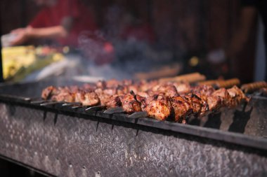 Kızarmış etli biftek, baharat ve otlarla birlikte, yanan kömürlerin içinde, bbq ızgarası, alevler ve duman. Izgara çizgili sulu biftek piknik kutlaması için hazır. Barbekü ızgarası