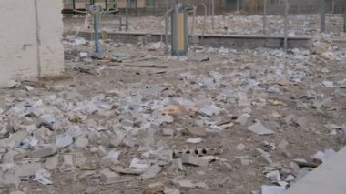 Consequences of the bomb dropped on the school. Russian military attacks from the air. Torn book opens from the wind.