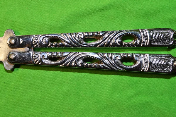 green military sword with a zipper on a black background