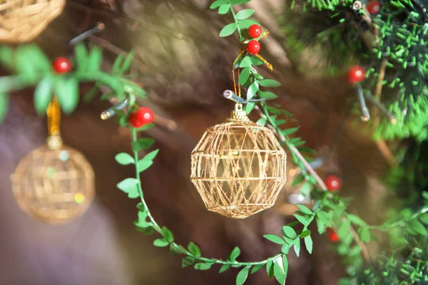 Golden christmas balls on green plastic fir. Golden Christmas decoration on Christmas tree — Stock Photo, Image