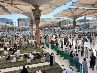 Mescid Al Nabawi, Madinah Cuma namazından sonra, çok sayıda hacı Mescid Al Nabawi 'nin dışındaki avluda toplandı. Ziyaretçiler, caminin dışındaki avlular ve elektronik şemsiyeler de görülebilir.