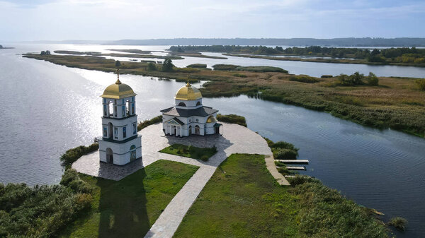 Top view of the restored church on the island in the village of Gusintsy 