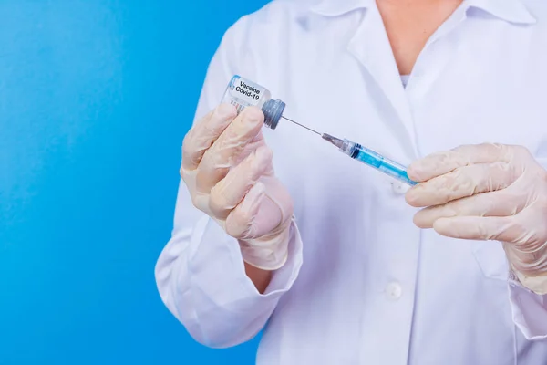 nurse holding covid 19 vaccine and syringe. Coronavac. Vaccination against the new Corona Virus Vacine-Covid19: A syringe being drawn up with Vacine-Covid 19.