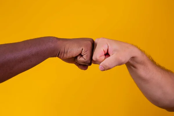 hands greeting against yellow background
